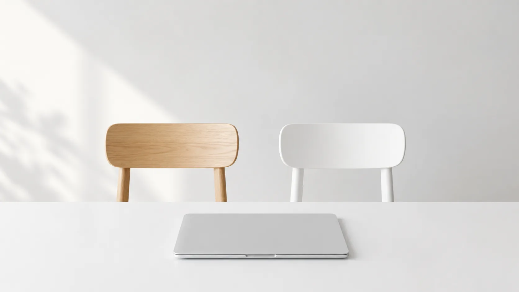 Two chairs side by side at a clean desk with a laptop — human and AI working together in customer service