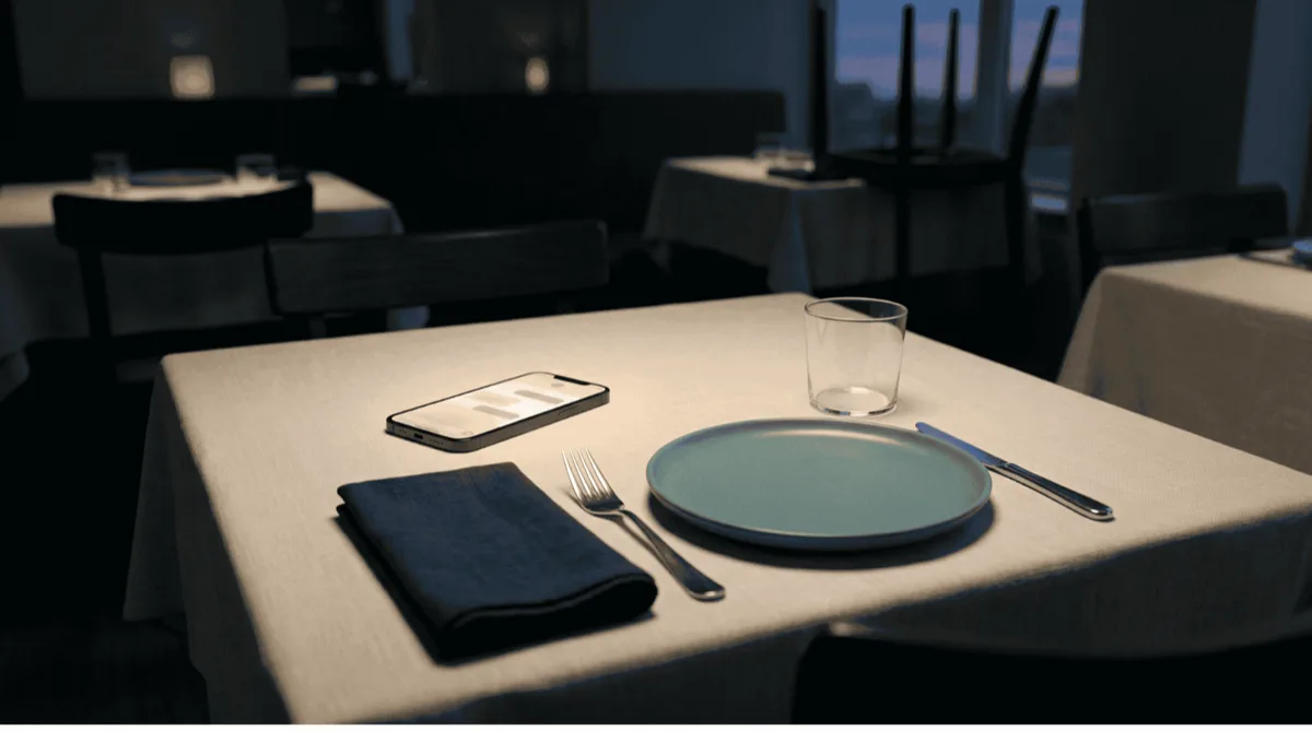 Restaurant table at dusk with glowing smartphone — AI handling after-hours reservations and menu questions